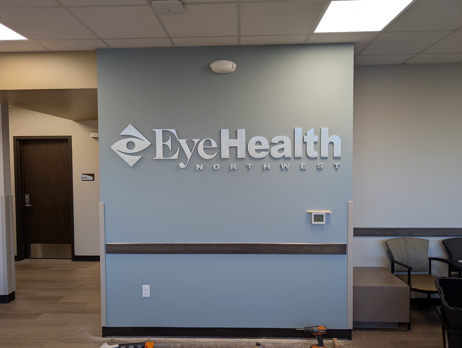 Brushed metal dimensional lobby sign with logo and letters in Portland, OR.